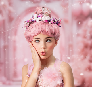Girl with pink wig and floral crown against a soft pink fantasy palace backdrop.