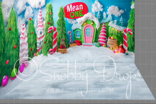 Whimsical snowy Christmas room set backdrop with candy canes, gingerbread house, and pink door.